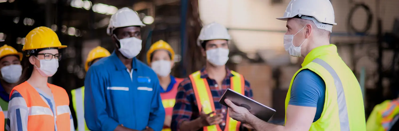 Staff wearing PPE in a workshop environment