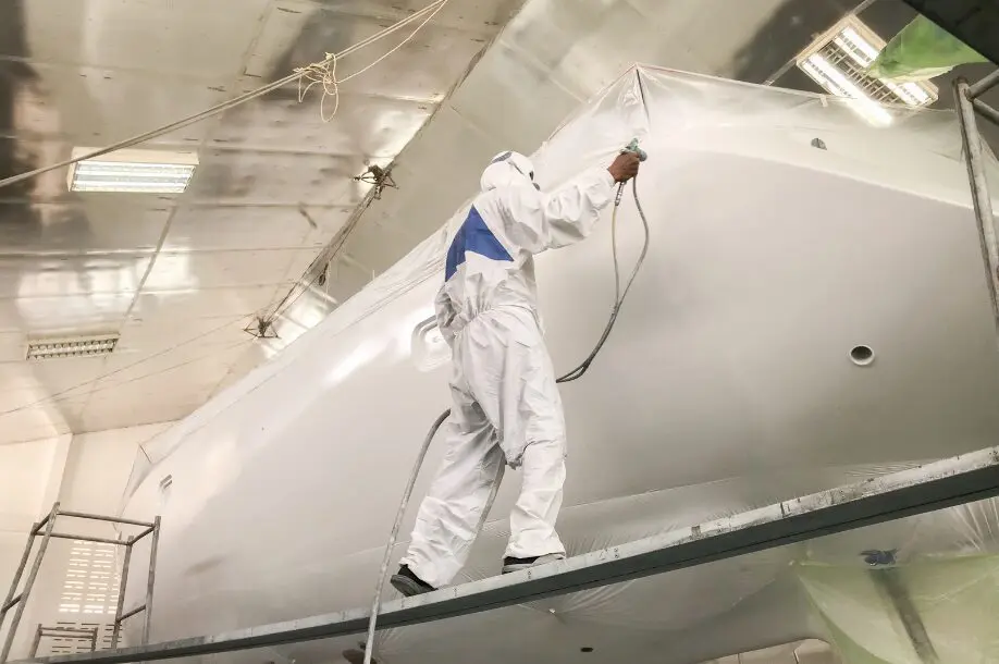 Marine Composites: How They are Used in the Marine Industry 1 Man Spraying a Yacht